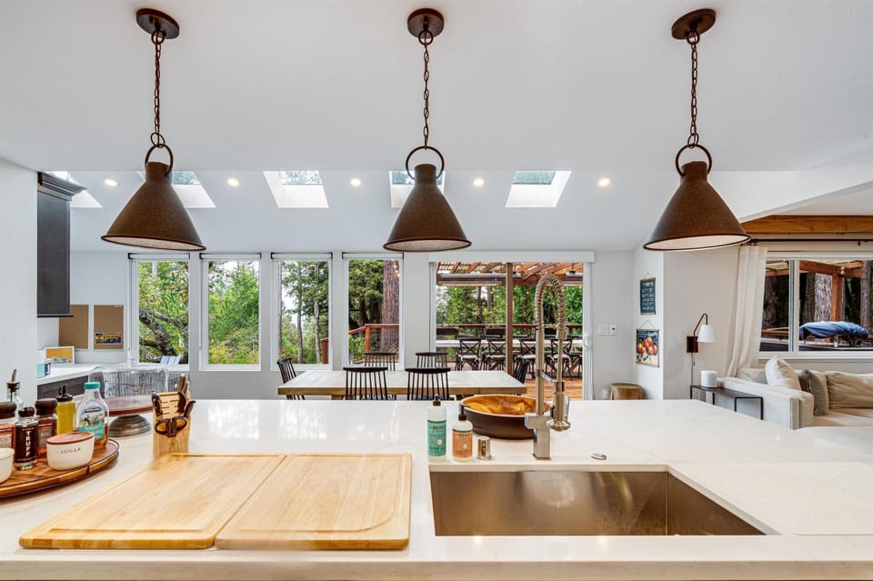 Sunlit kitchen with modern island and garden views