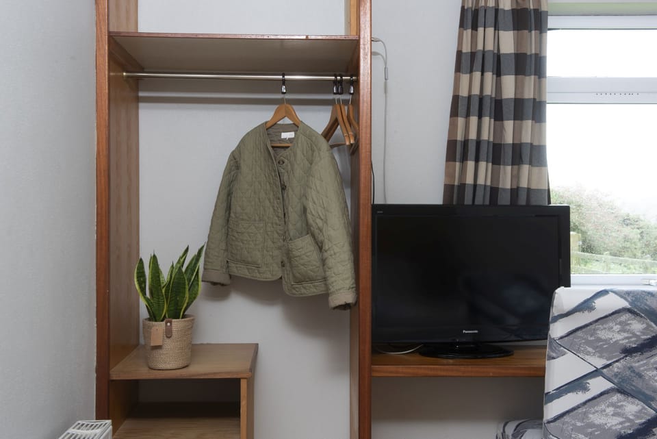 Clothes hanging rail and shelves