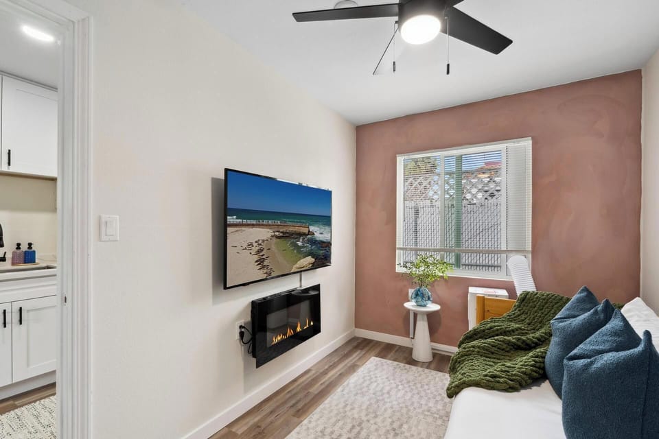 Enjoy natural light streaming through the large vertical blinds, complemented by soft recessed lighting while enjoying your large flat screen tv.
