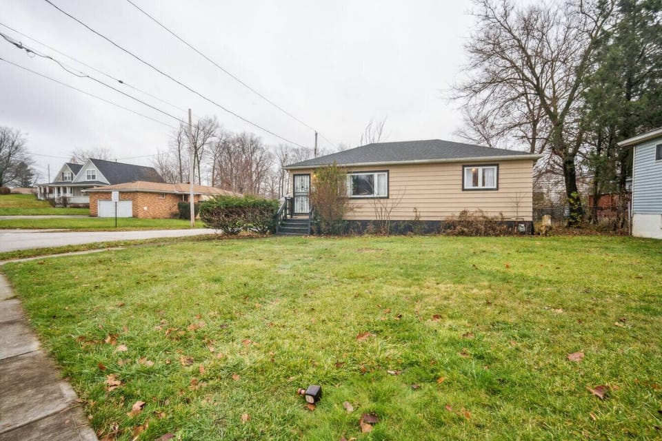 This charming home features a spacious grassy lawn and a quiet neighborhood setting, offering a peaceful and private retreat for your stay.