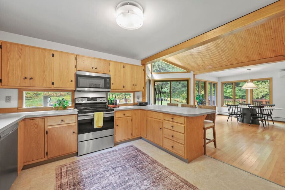 Large open kitchen with all the necessary amenities, including seating for three at the breakfast bar.