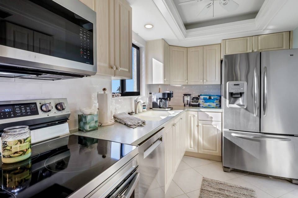 The kitchen is well equipped with a smooth-top double oven, dishwasher, refrigerator/freezer and microwave.