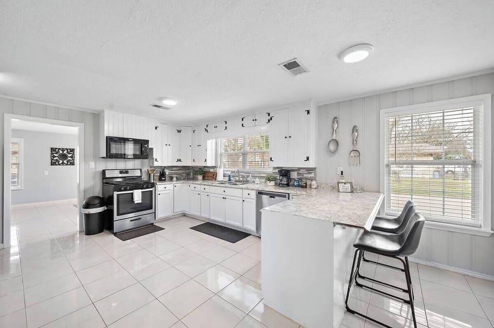 Kitchen: Sleek design with modern appliances and ample bar seating for culinary fun!