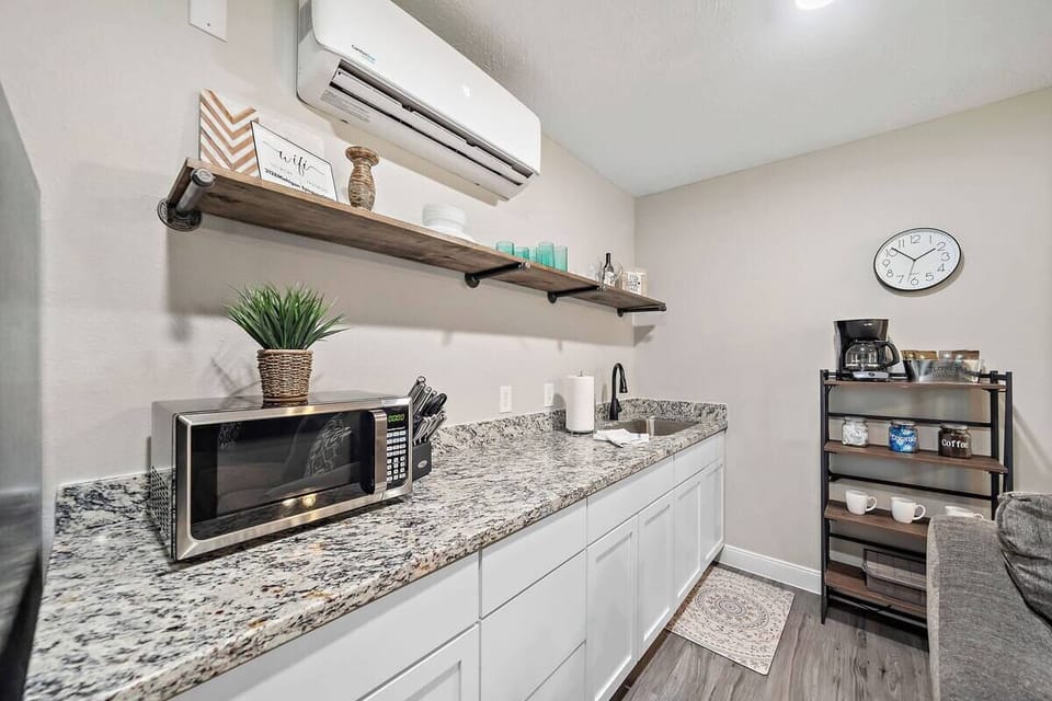 Kitchenette: Whip up meals in style with granite counters and modern appliances!