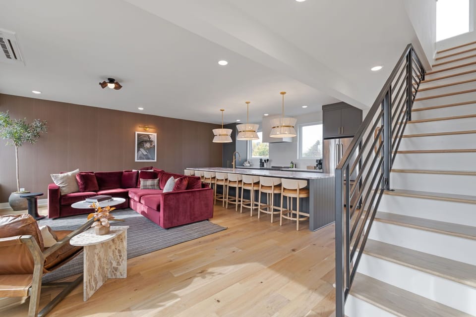 Spacious living and dining area with sleek staircase.