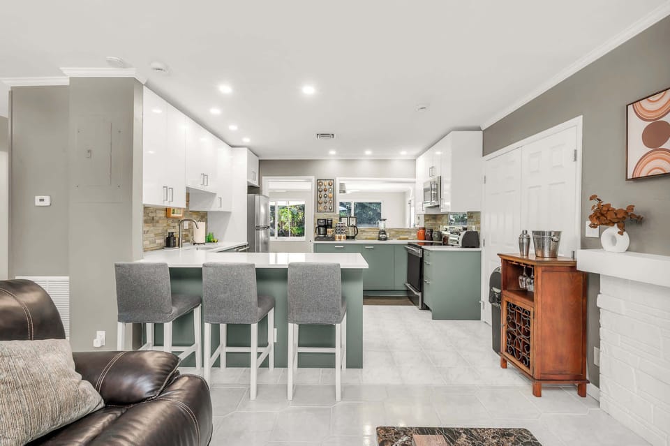Kitchen with breakfast bar seating for four, open to the living room.
