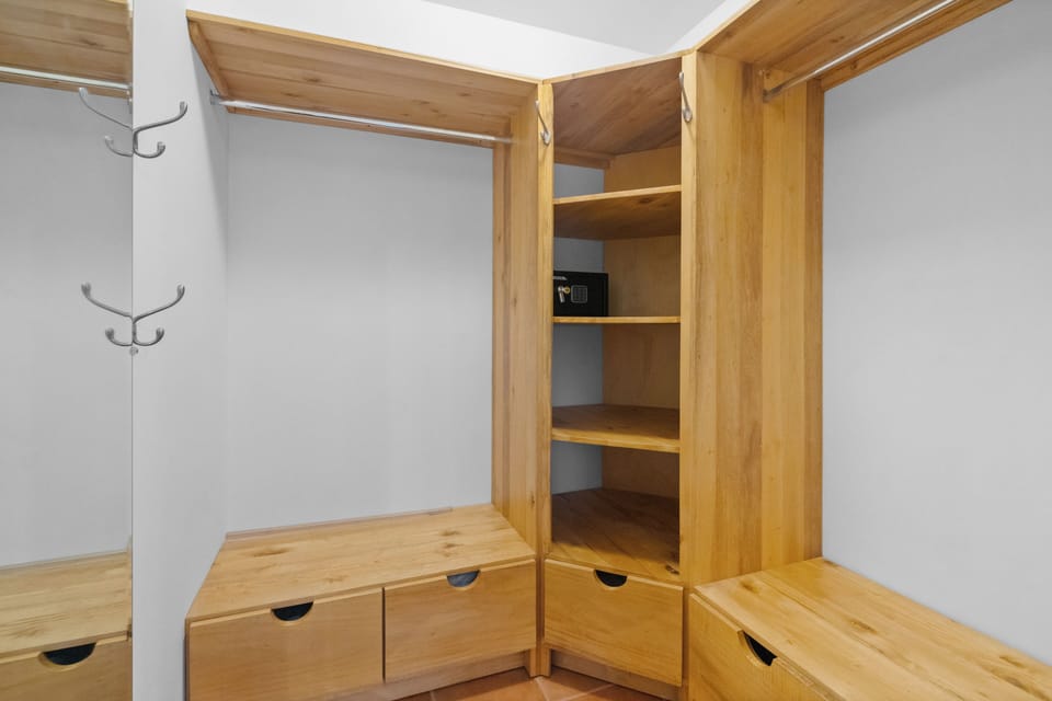 The primary bedroom's walk-in closet has lots of space for clothes storage, along with a safe for your valuables.  