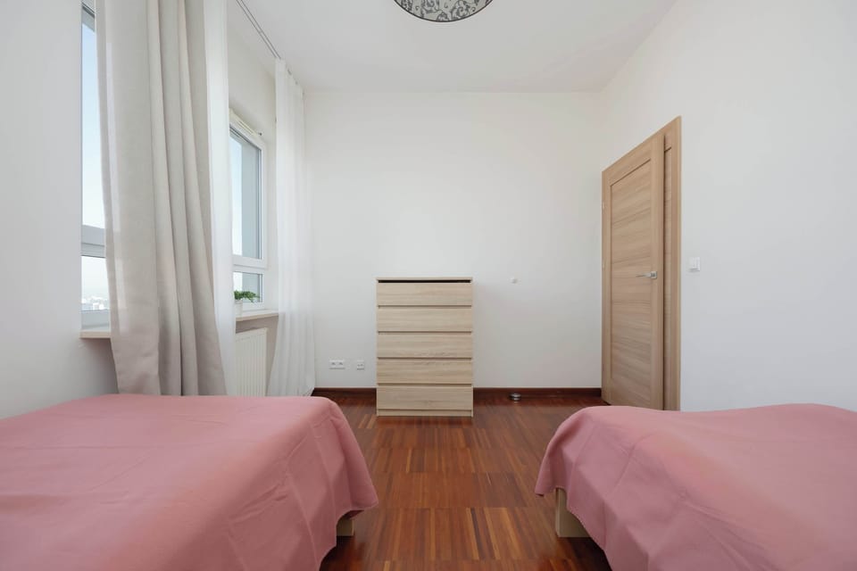 Twin bedroom with two single beds and a simple, clean look.