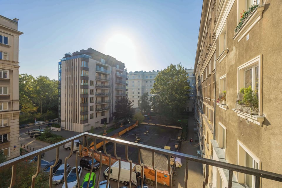 The view from the balcony over the city street lets guests experience the everyday rhythm of urban life.