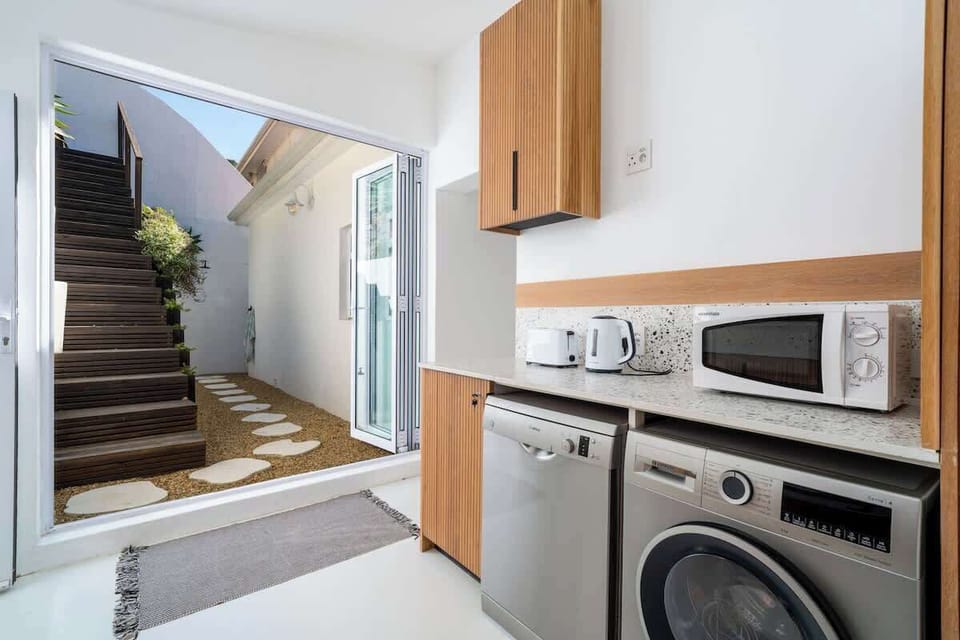 The scullery area is equipped with a washing machine and a dishwasher.