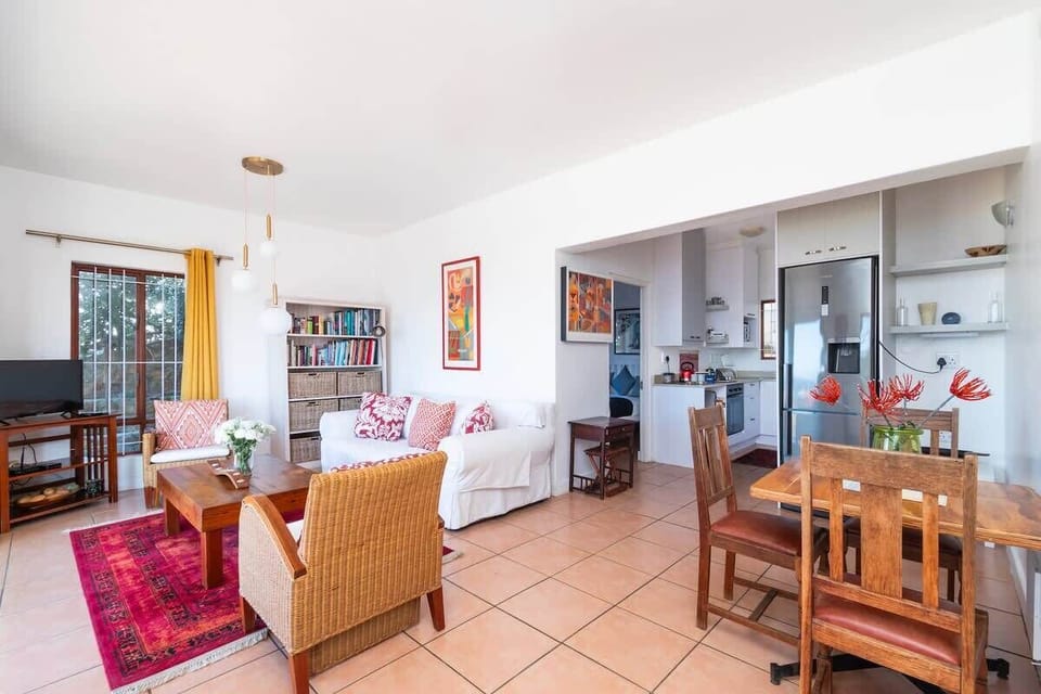 Open plan living space including kitchen, dining space and lounge which opens onto the balcony area.