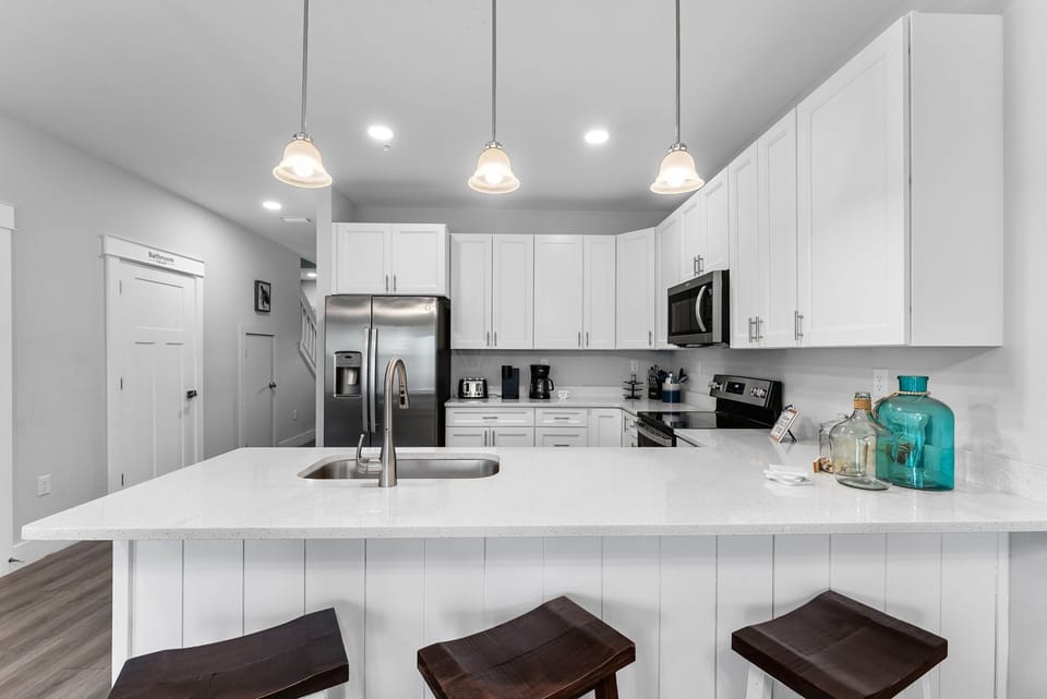 modern kitchen with white cabinetry and stainless steel appliances