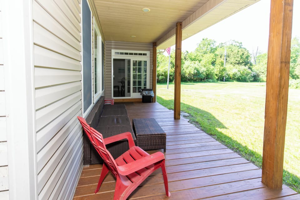 Unwind on your private porch with a refreshing drink and take in the peaceful views of the spacious lawn and tree-lined surroundings. Perfect for quiet mornings or relaxing afternoons.