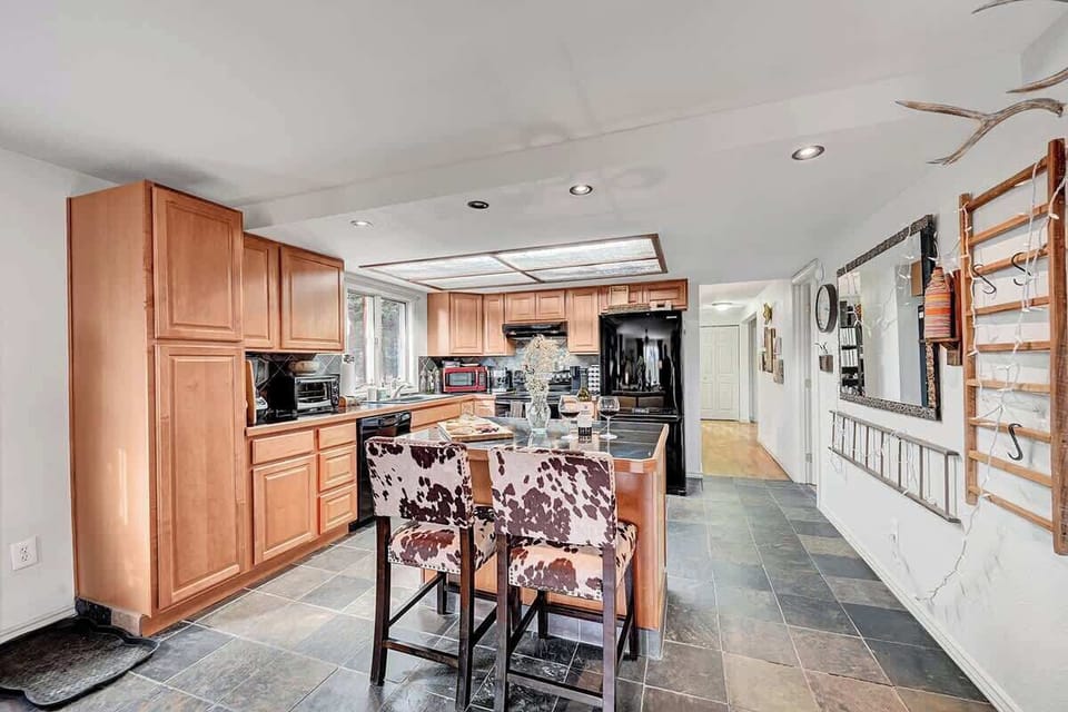 Spacious, fully equipped kitchen with stainless steel appliances and open layout, great for home-cooked meals.