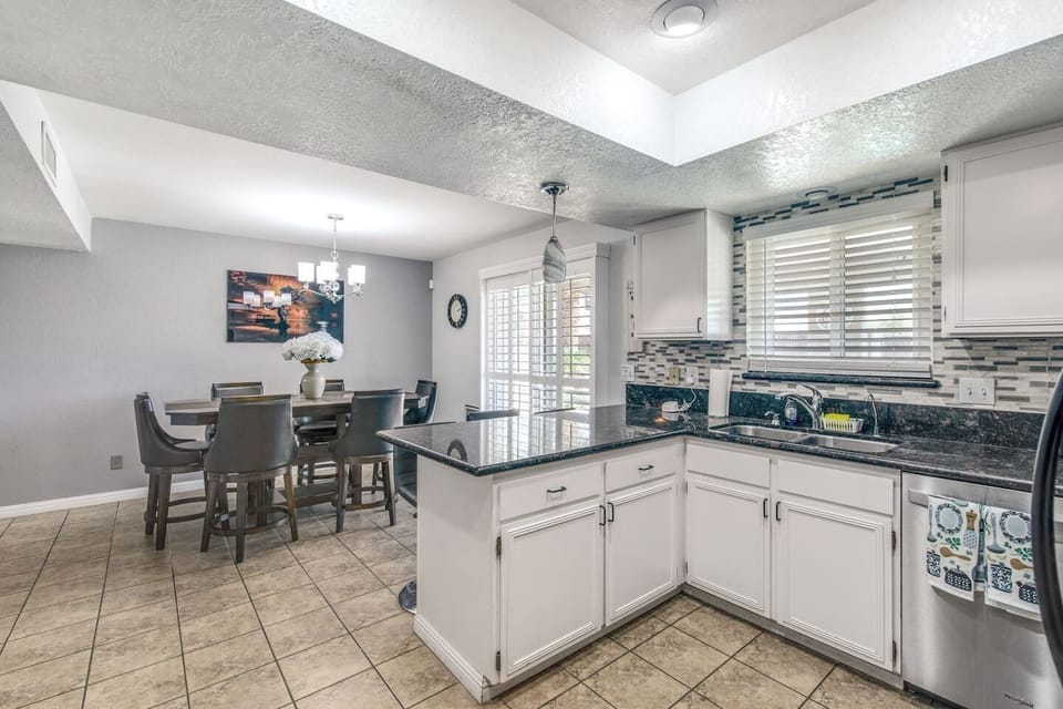 Spacious kitchen with modern appliances and plenty of counter space, perfect for cooking and entertaining.