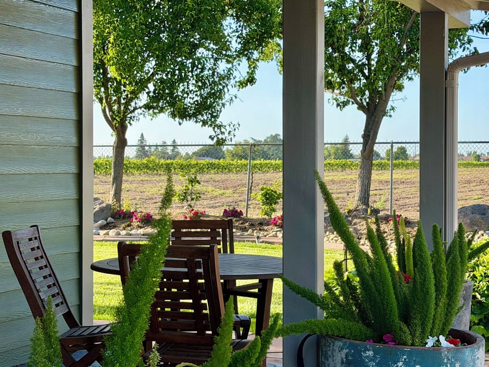 Guesthouse front porch area and enjoy your wine and cheese at a table for two.