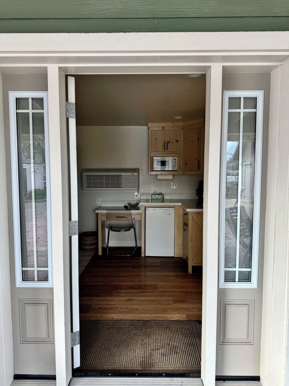 As you enter - a desk, small refrigerator, microwave, and coffee maker.