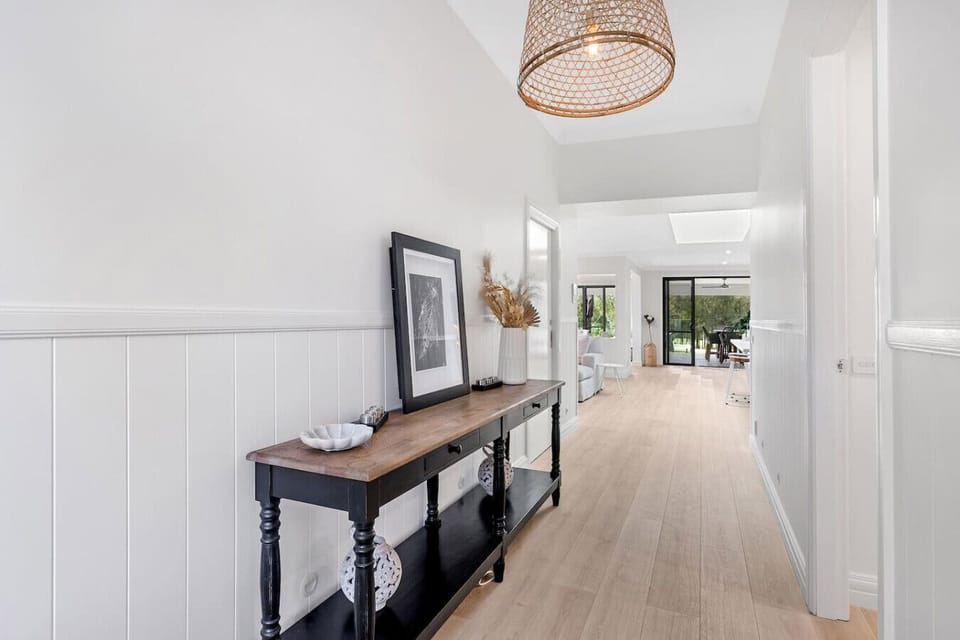 The entry way provides views through to the golf course at the back of the house. You can access Beds 2, 3 and 4 down the right hallway or continue through to the living and master bed and multiple outdoor spaces