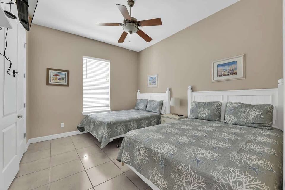 Queen Bedroom: Inviting bedroom with two queen beds and beach-inspired accents. 