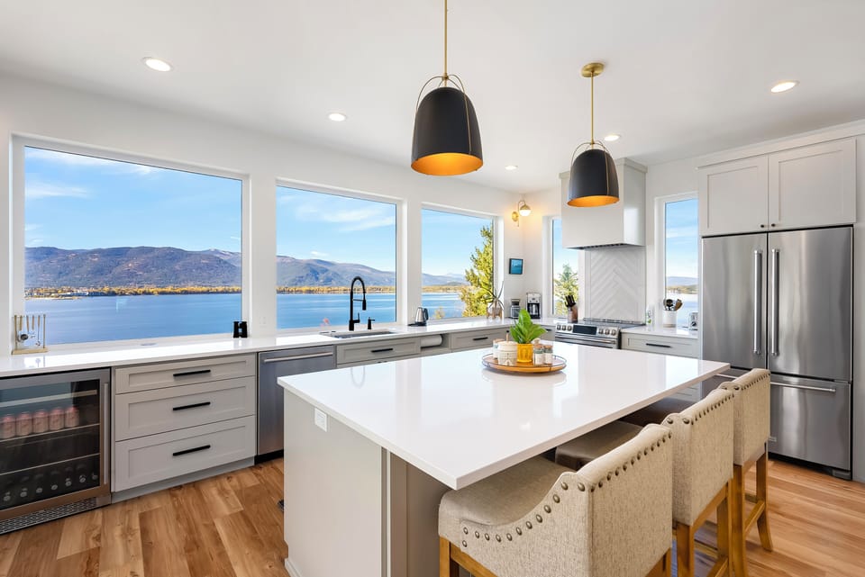 A true chef's kitchen with a spacious lake and mountain view. 
