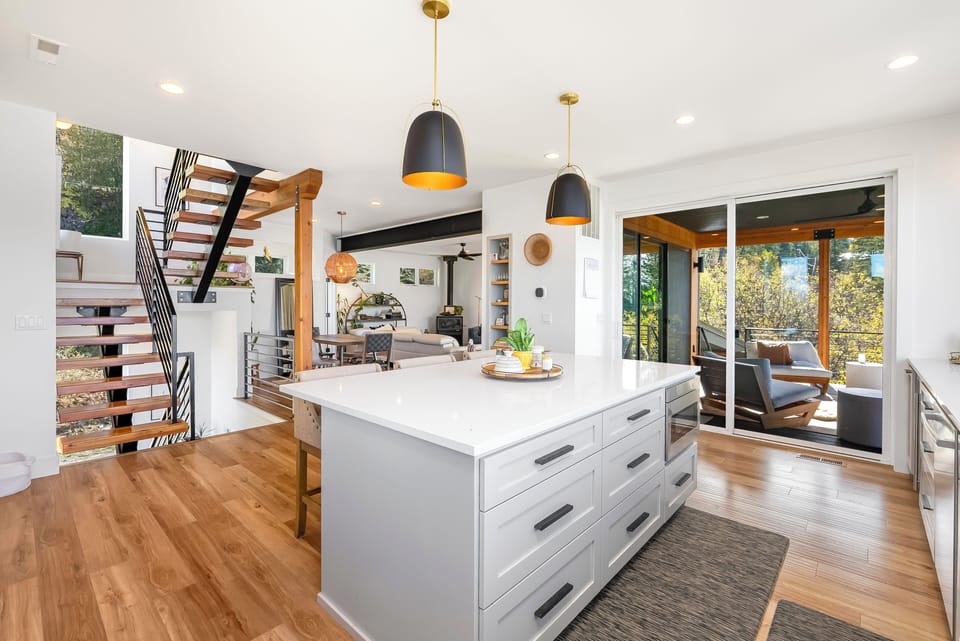 Kitchen view facing the dining, living and stairwell areas. Deck to the side. 