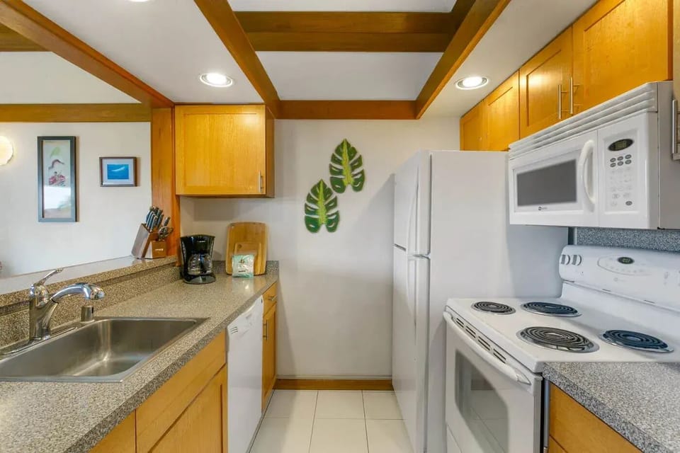 Bright, fully stocked kitchen with granite counters—cook easy, dine island-style.