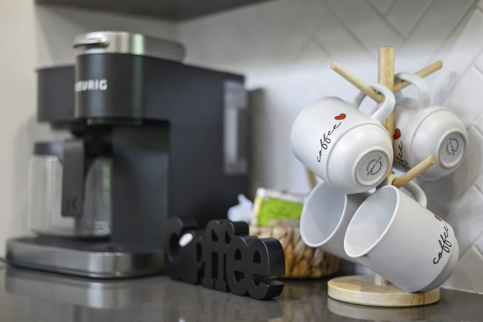 A cozy coffee station featuring a Keurig and stylish mugs, ensuring a great start to your mornings.