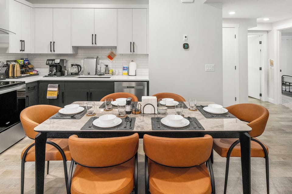 This dining table is made for family diners, friendly laughter and making memories. This space comfortably seats six people with flatware, drinkware and utensils provided. Child friendly dinnerware and high chair also provided in this private suite.