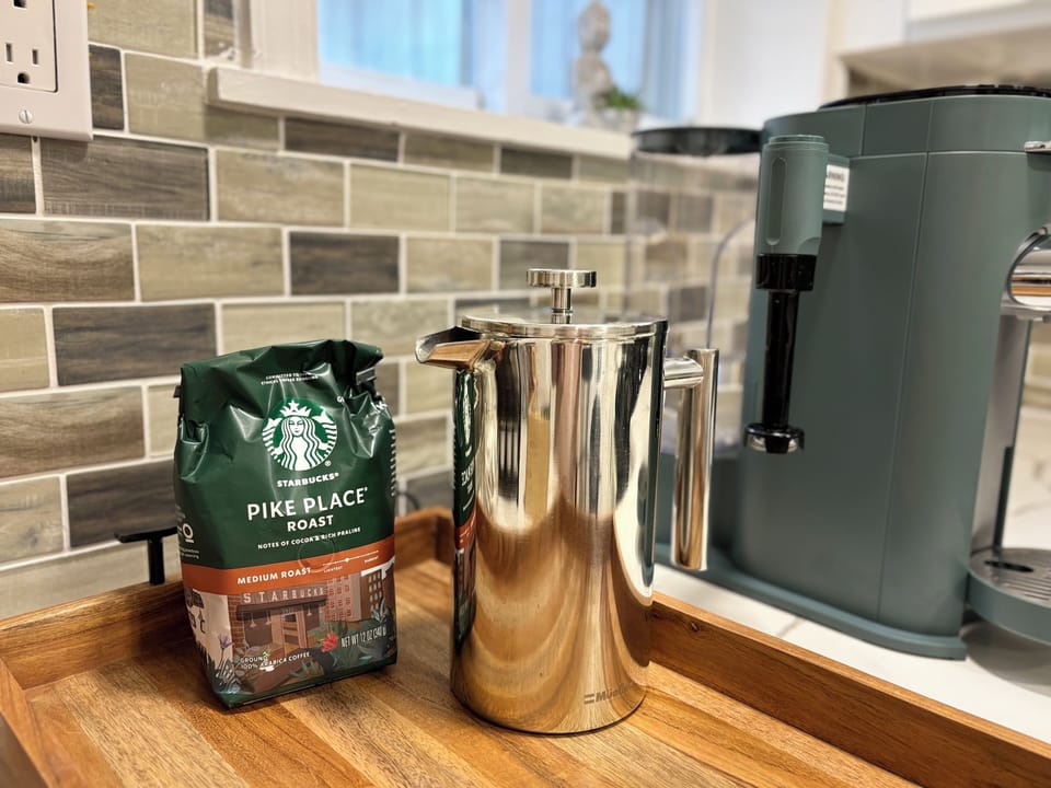 Coffee bar with French press & milk frother for the perfect morning brew.