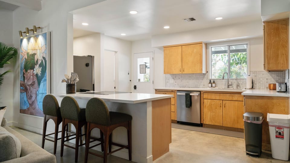 Bright open kitchen with island seating for 3 and modern finishes