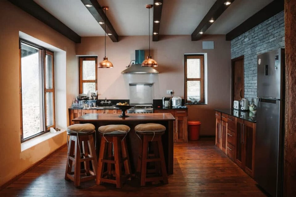 Modern kitchen with breakfast bar and copper pendant lighting.