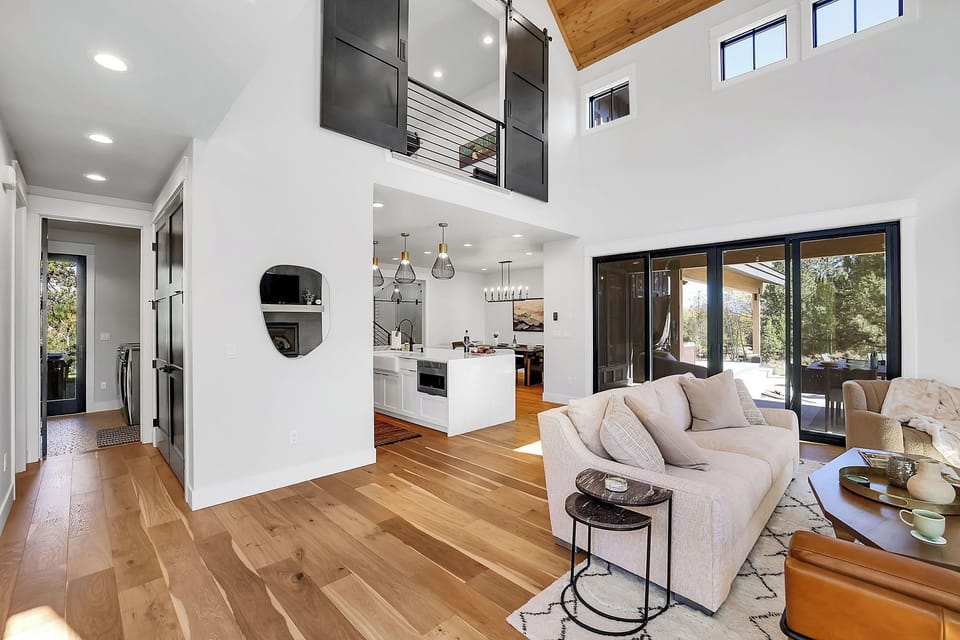 Bright and Airy Great Room: Vaulted ceilings and large windows fill the space with natural light, creating a welcoming and vibrant atmosphere. The floorplan is super functional and homey.
