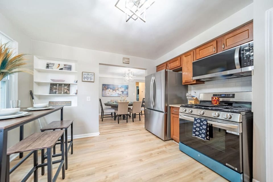 Cook with ease in this updated kitchen featuring sleek stainless steel appliances, a modern gas range, plenty of counter space, and all tied together by stylish wood cabinetry.