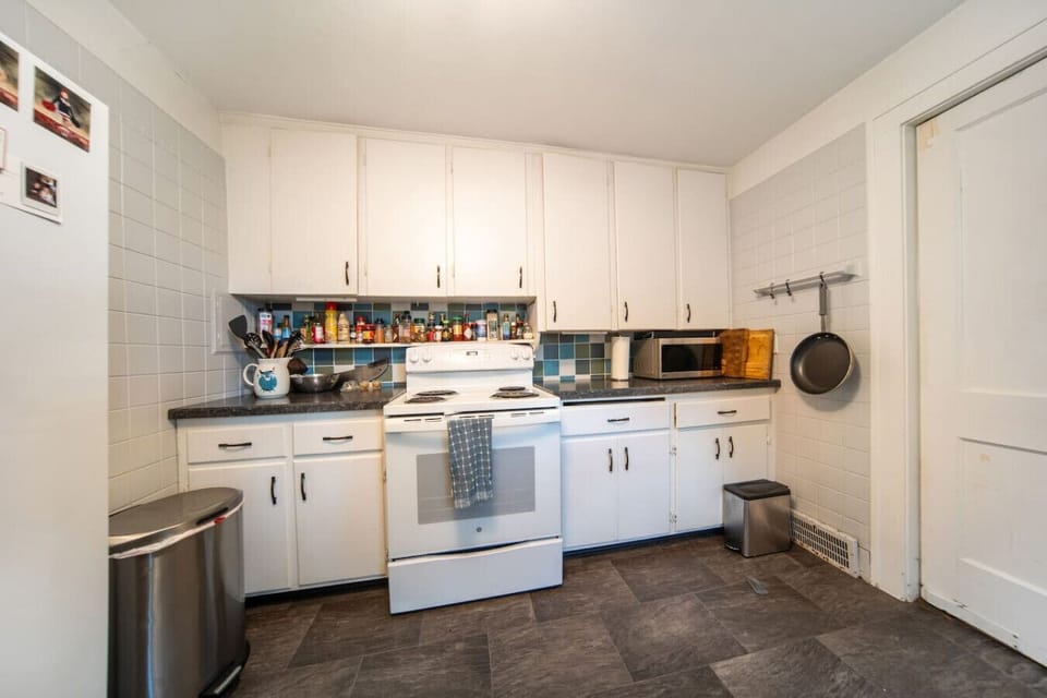 Prepare your favorite meals in this modern kitchen, featuring sleek stainless steel appliances, ample cabinet space, and bright recessed lighting.