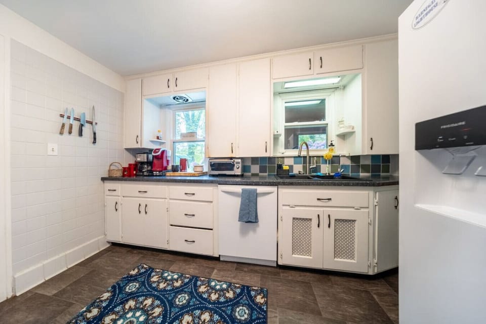Prepare your favorite meals in this modern kitchen, featuring sleek stainless steel appliances, ample cabinet space, and bright recessed lighting.