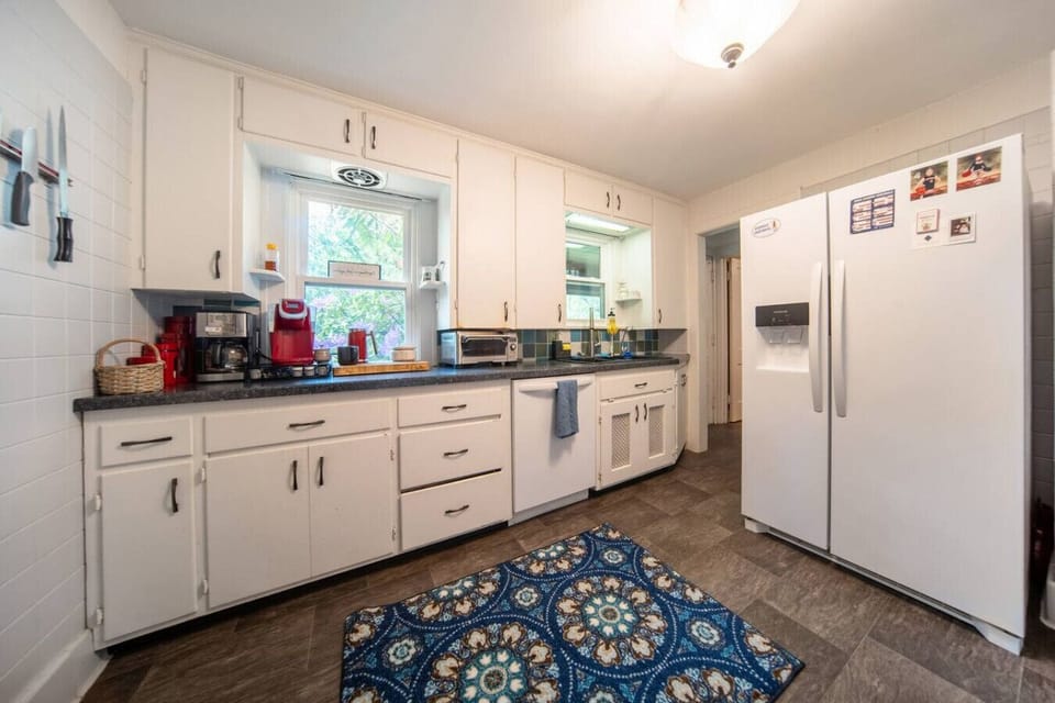 Prepare your favorite meals in this modern kitchen, featuring sleek stainless steel appliances, ample cabinet space, and bright recessed lighting.
