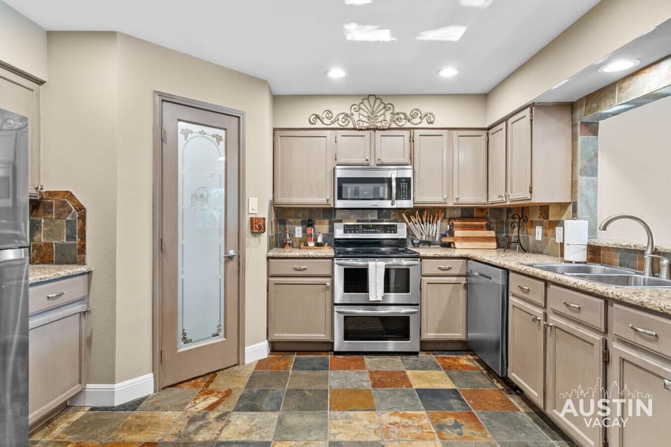Double ovens, slate floors, and a layout that makes cooking feel like a treat.