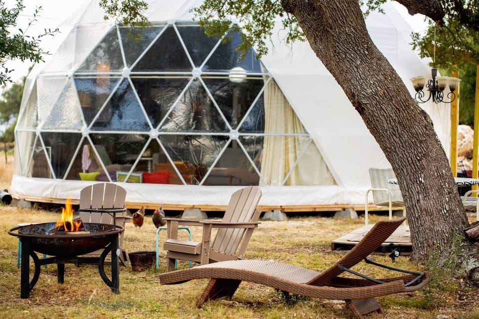 Unwind beneath the oaks — cozy fire pit, outdoor seating, and starlit skies await at The Dome at Purgatory Road.