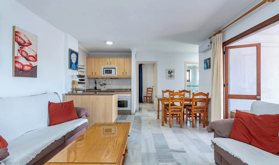 A living room with a sofa, coffee table, and a dining table. A cozy and inviting space living room.
