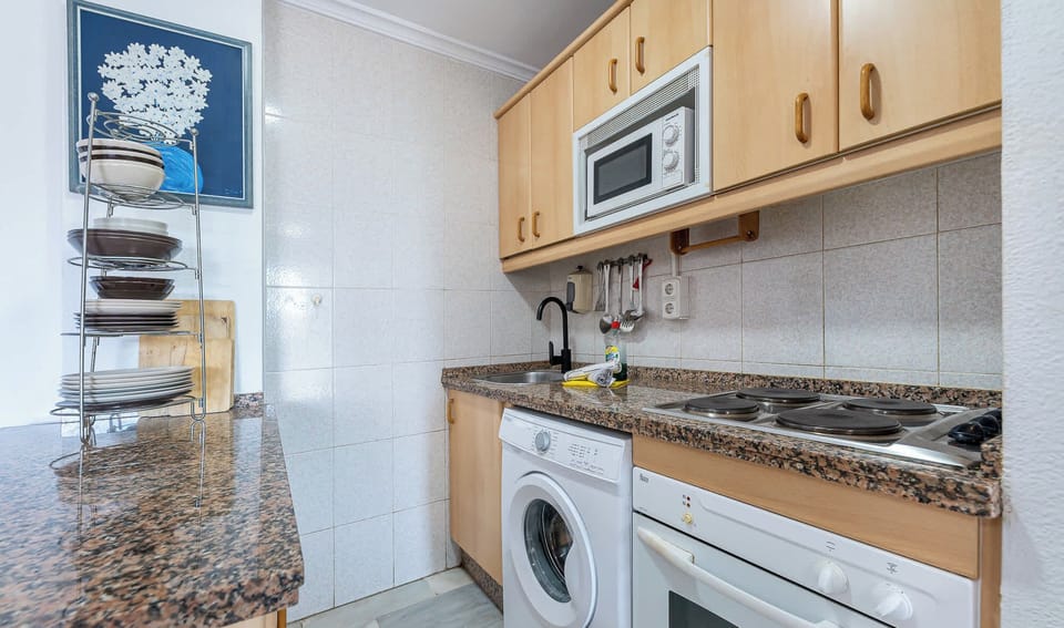 A kitchen with wooden cabinets and appliances. A functional space for cooking kitchen.
