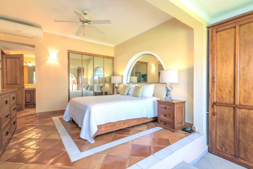 Cozy bedroom with terracotta floors, modern lighting, and classic charm.