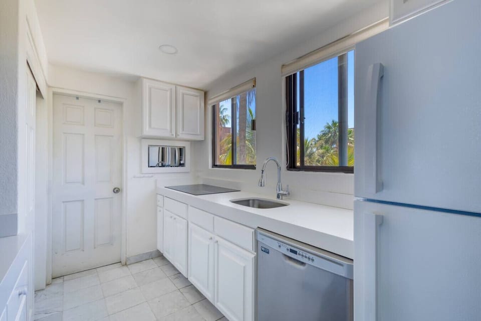 The bright kitchen features a breakfast bar that opens up to the dining and living areas, offering beautiful ocean views while you cook.