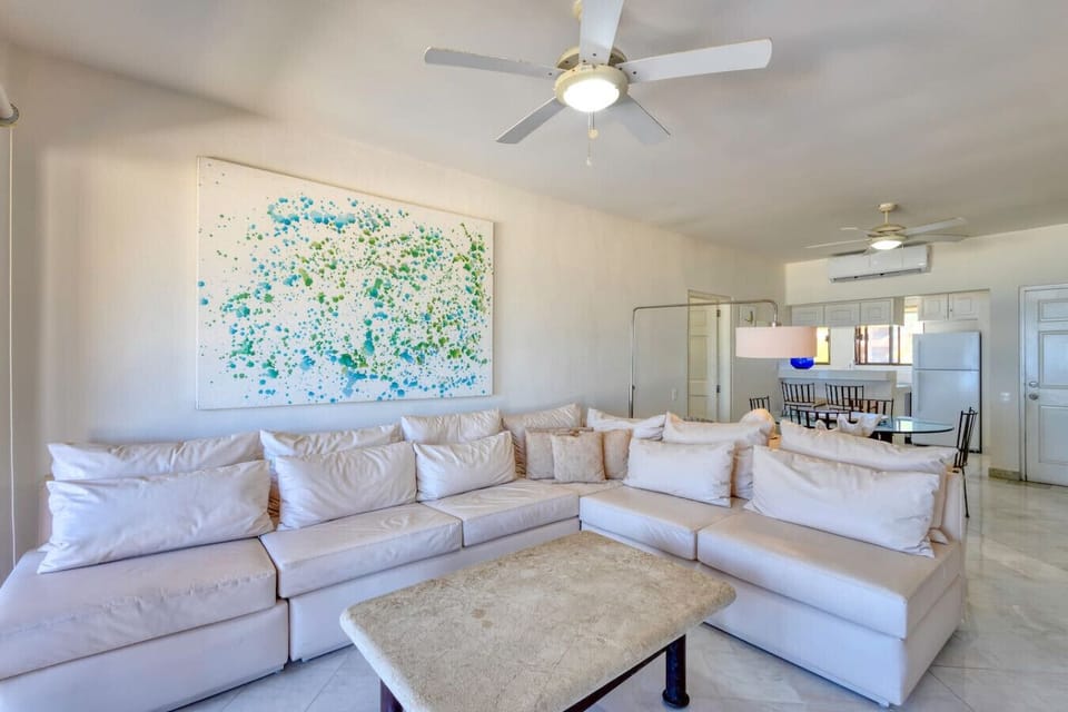 A cozy corner of the living room showing the entertainment center and the seamless flow to the oceanfront balcony.