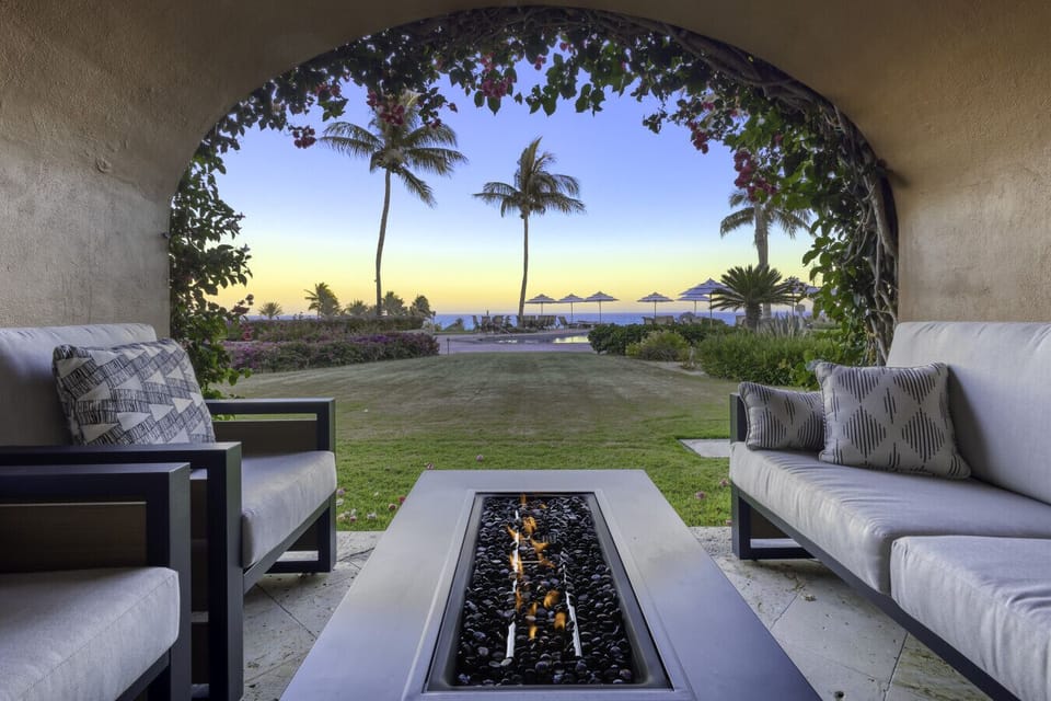 Cozy covered terrace with comfy chairs and lush garden views—perfect for morning coffee or sunset wine.