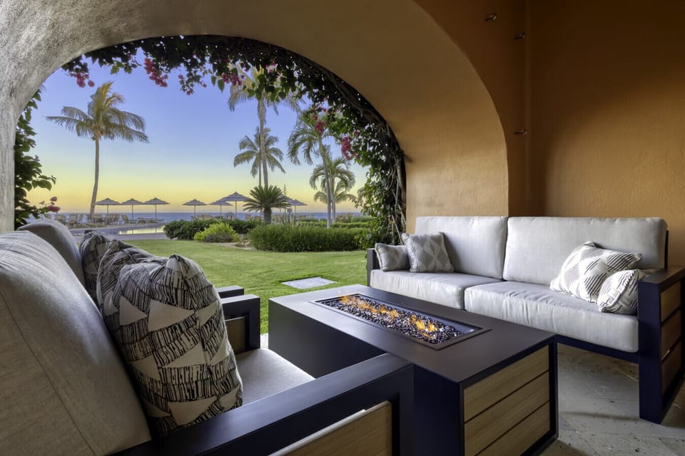 Dine al fresco under the palms with ocean and pool views. A peaceful spot for any meal.