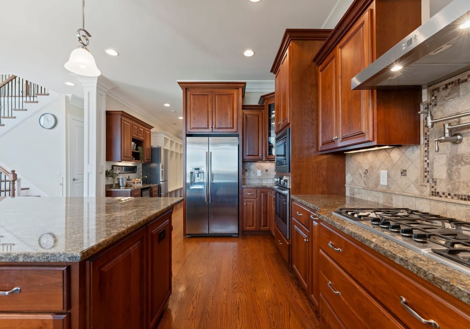 Fully stocked kitchen with island seating for 6.