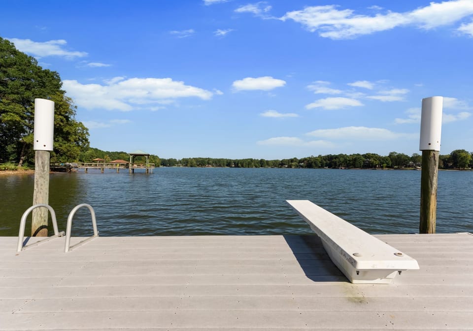 Dock with large swimming platform including a diving board and ladder.
