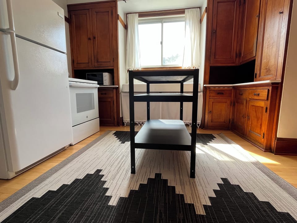 Full kitchen with refrigerator, stove/oven, microwave, toaster, & coffee maker.