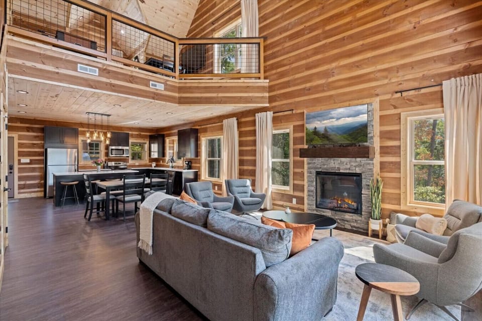 Open living area with electric fireplace, beautiful high ceilings and a smart TV!