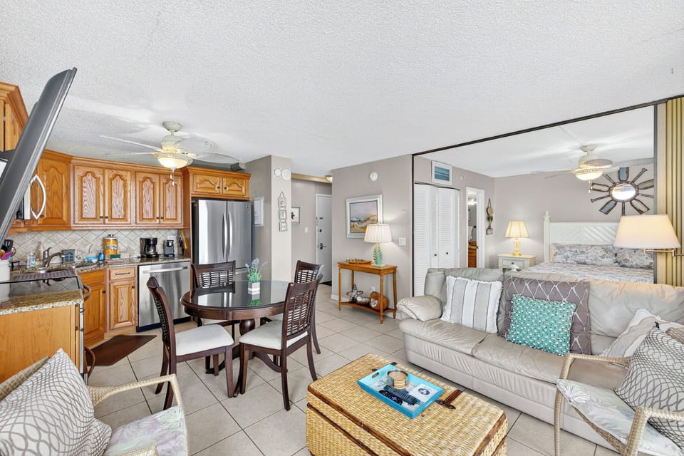 Bright and inviting studio at Estero Beach & Tennis Club featuring an open layout with a full kitchen, cozy living area, and comfortable sleeping space—perfect for a relaxing Fort Myers Beach getaway.